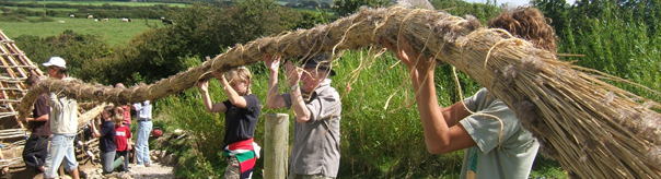 young volunteers thatching the new Celtic roundhouse at the Felin Uchaf Education Centre,Aberdaron